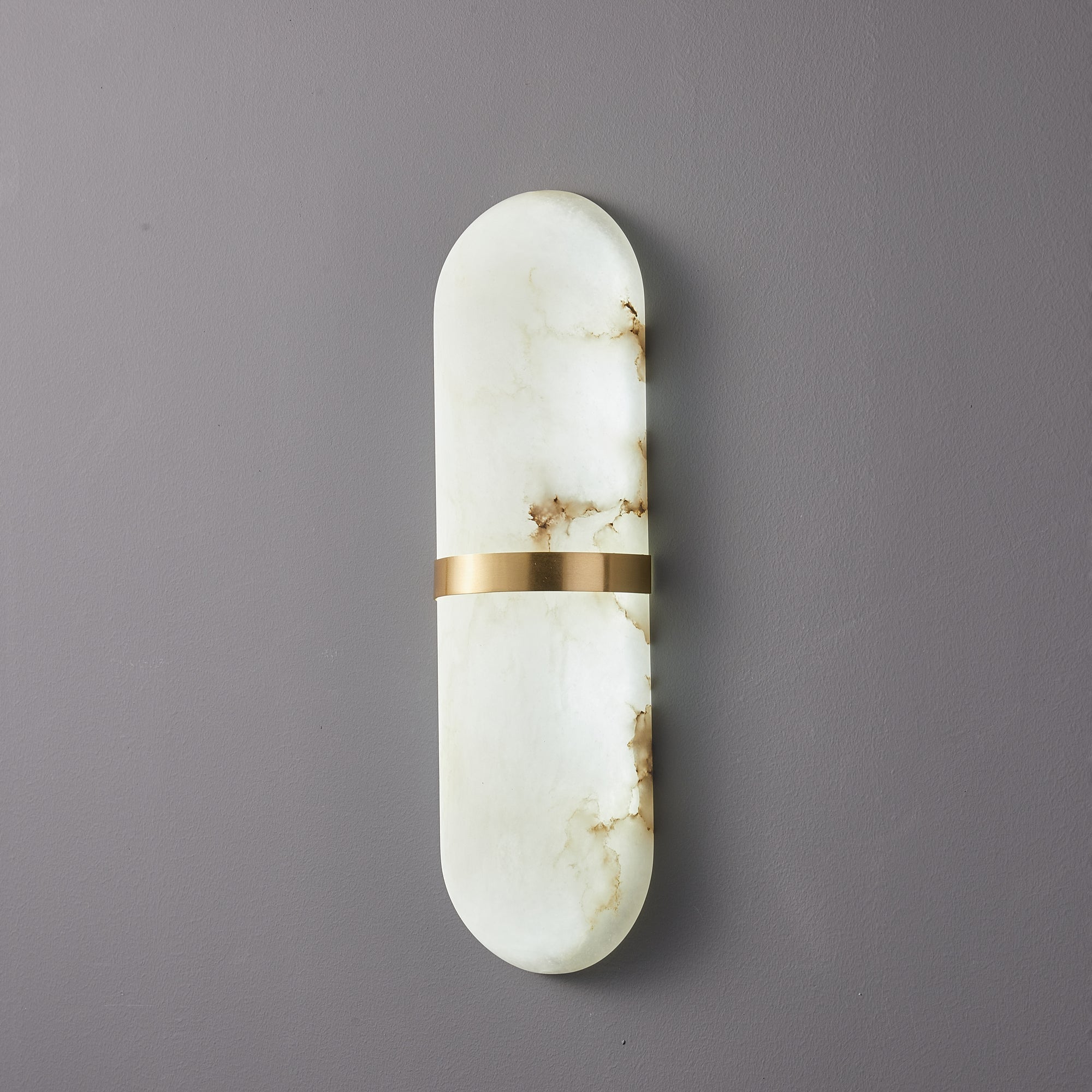 Clérachic three-quarter view of the unlit brass-banded alabaster lamp, showing the shade's rounded depth