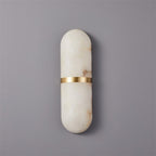 Clérachic wide Ostruvyd alabaster wall lamp with brass band, unlit on a pale grey wall showing rust veining