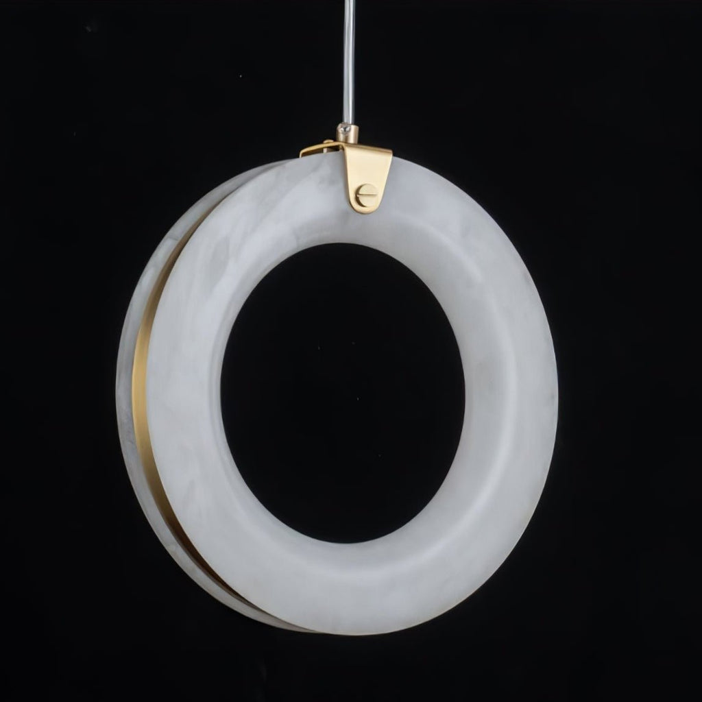 Close-up of the alabaster ring's marbled surface with the brushed brass ring visible behind it
