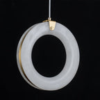 Close-up of the alabaster ring's marbled surface with the brushed brass ring visible behind it