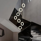 Close view of the seven-ring stairwell cascade, each alabaster ring lit at a different level