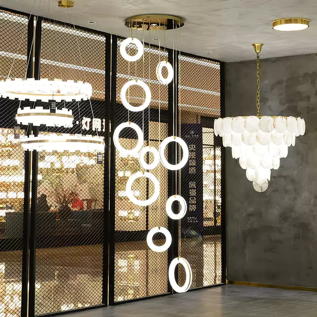 Alabaster ring pendants arranged as a long cascade in a lighting showroom window display