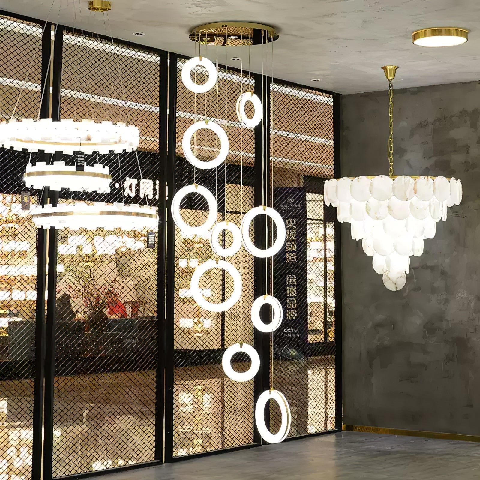 Alabaster ring pendants arranged as a long cascade in a lighting showroom window display