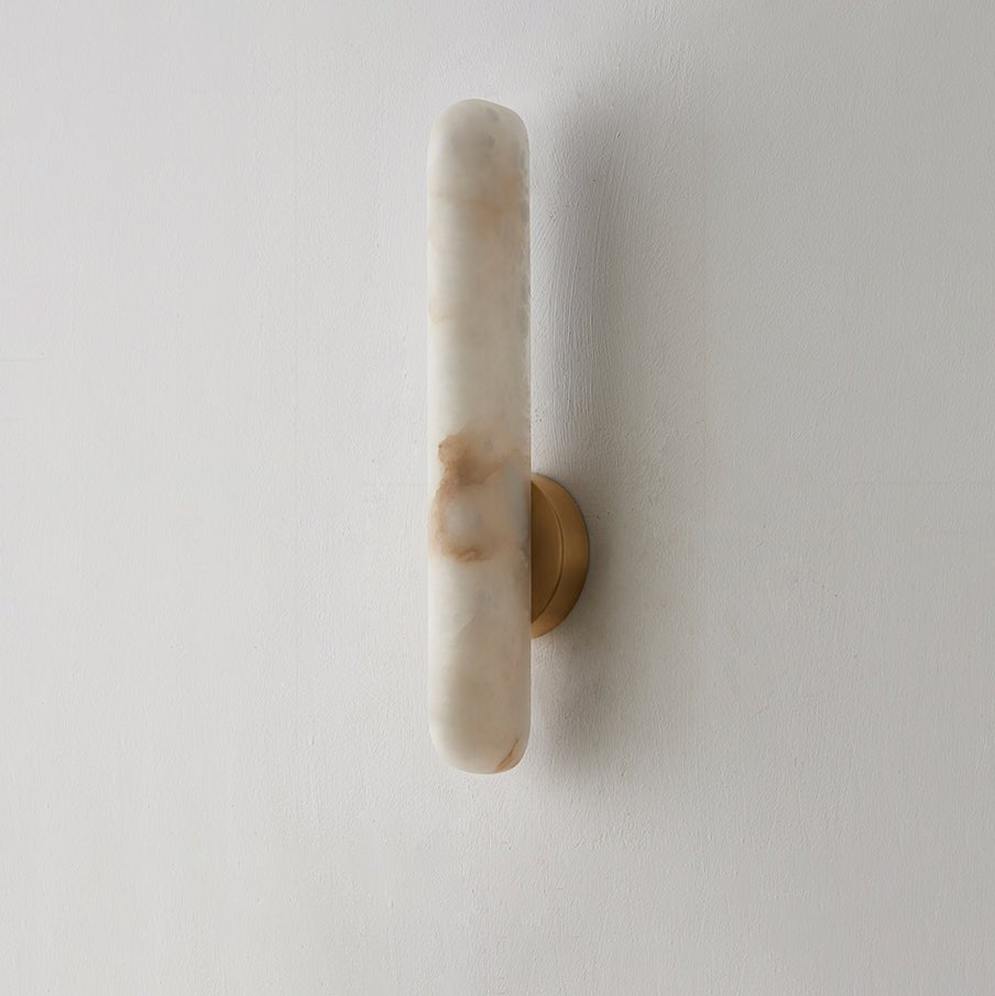 The same sconce unlit on white, showing the rust-toned veining running through the alabaster.