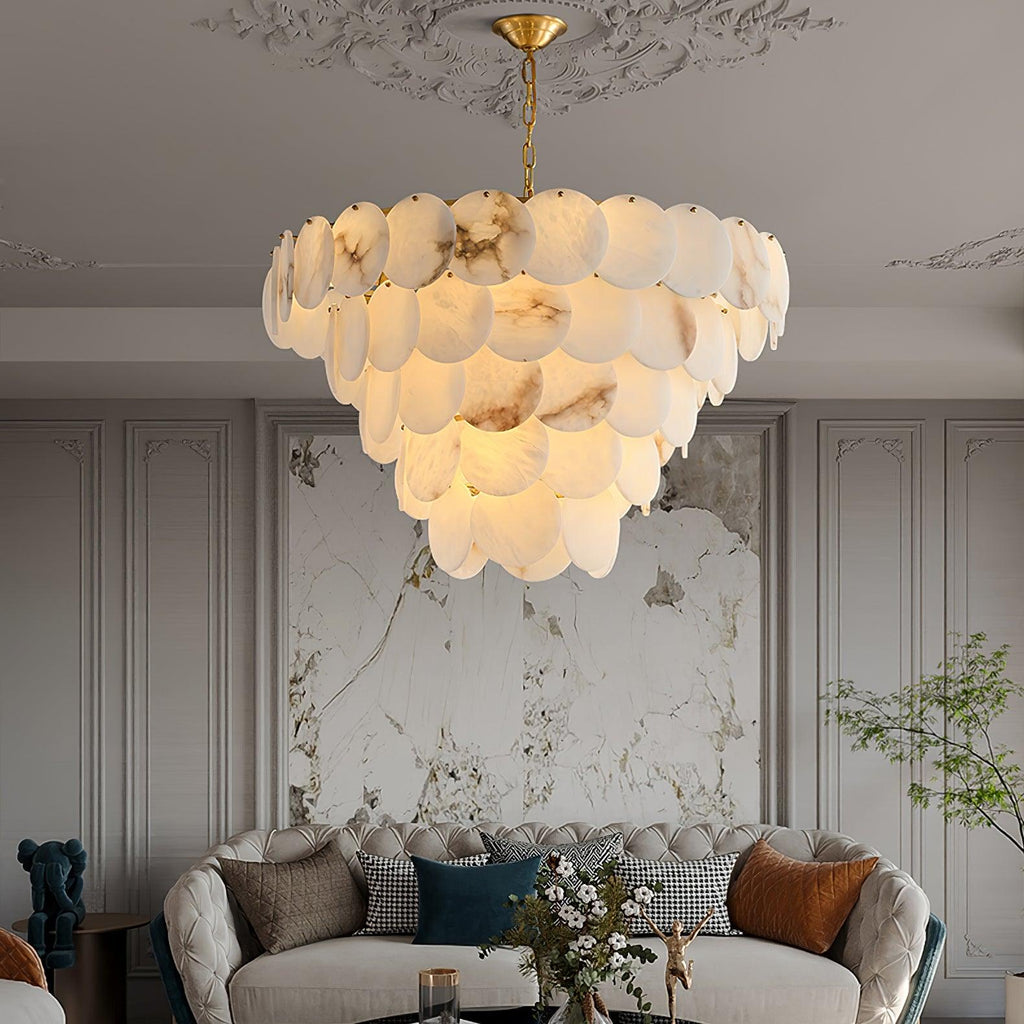 Lit in a living room above a sofa, with a textured plaster artwork on the wall behind.