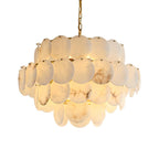 The three-tier version lit, the discs' veining showing warm against the pale stone.