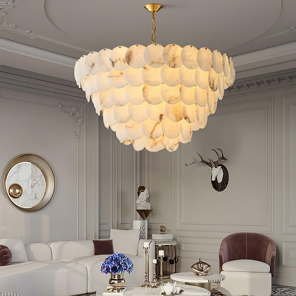 Lit in a grey panelled living room, between a round mirror and a mounted antler sculpture.