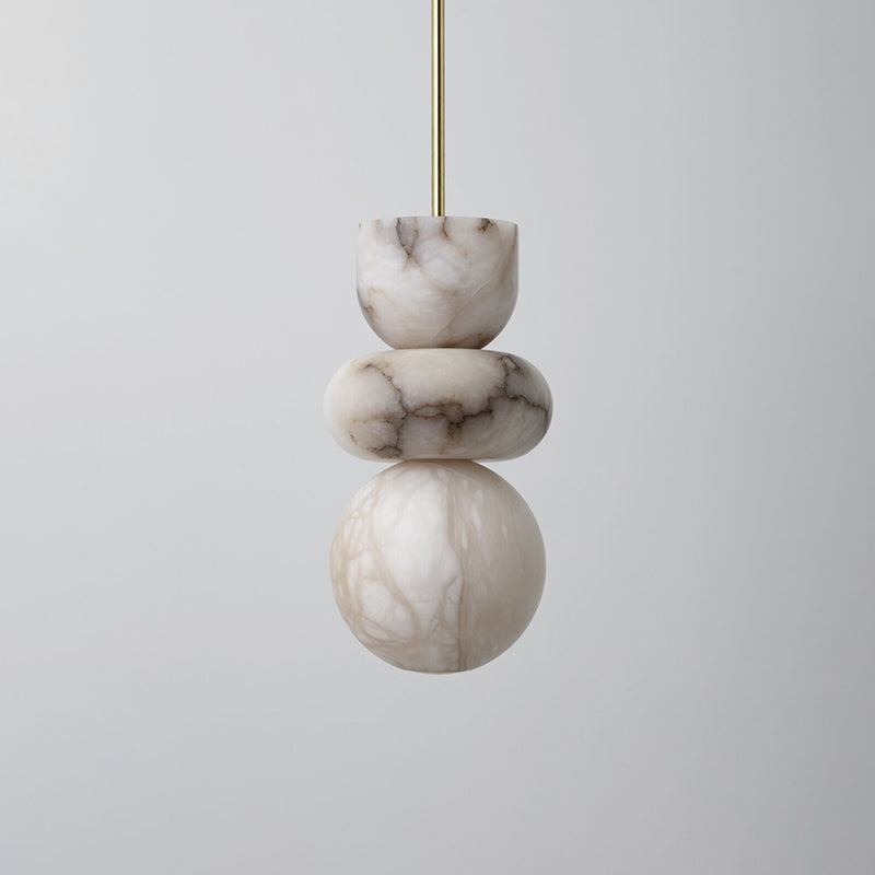 Veining detail across the alabaster pendant's bowl, disc and globe, switched off on a plain grey background