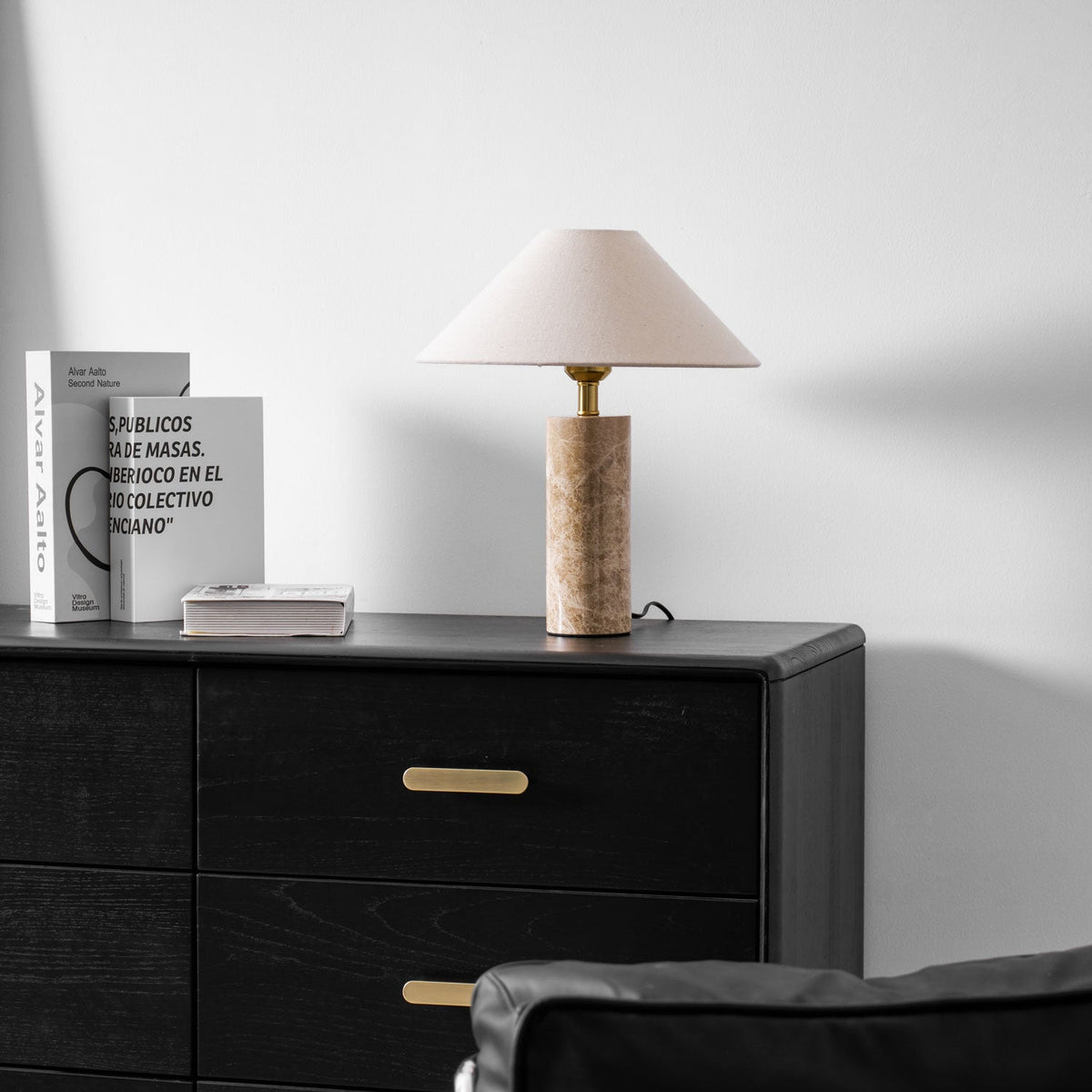 The Clérachic table lamp on the dresser, its gold drawer pull centred beneath the shade and the chair visible at the corner.