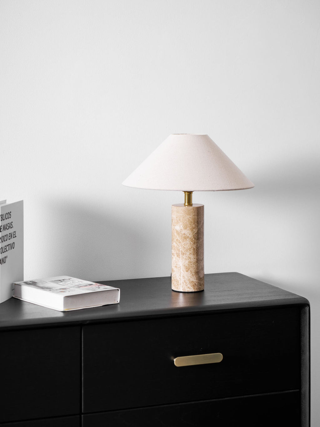 A tighter crop of the dresser scene, the Clérachic table lamp's books stacked close with no chair in view.