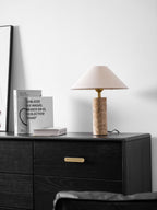 The framed print reappears at the left edge as the Clérachic table lamp glows above the dresser and its books.
