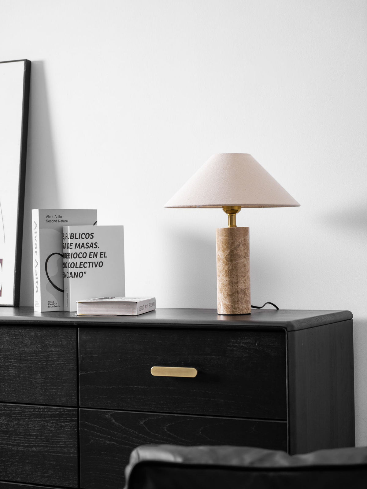 The framed print reappears at the left edge as the Clérachic table lamp glows above the dresser and its books.