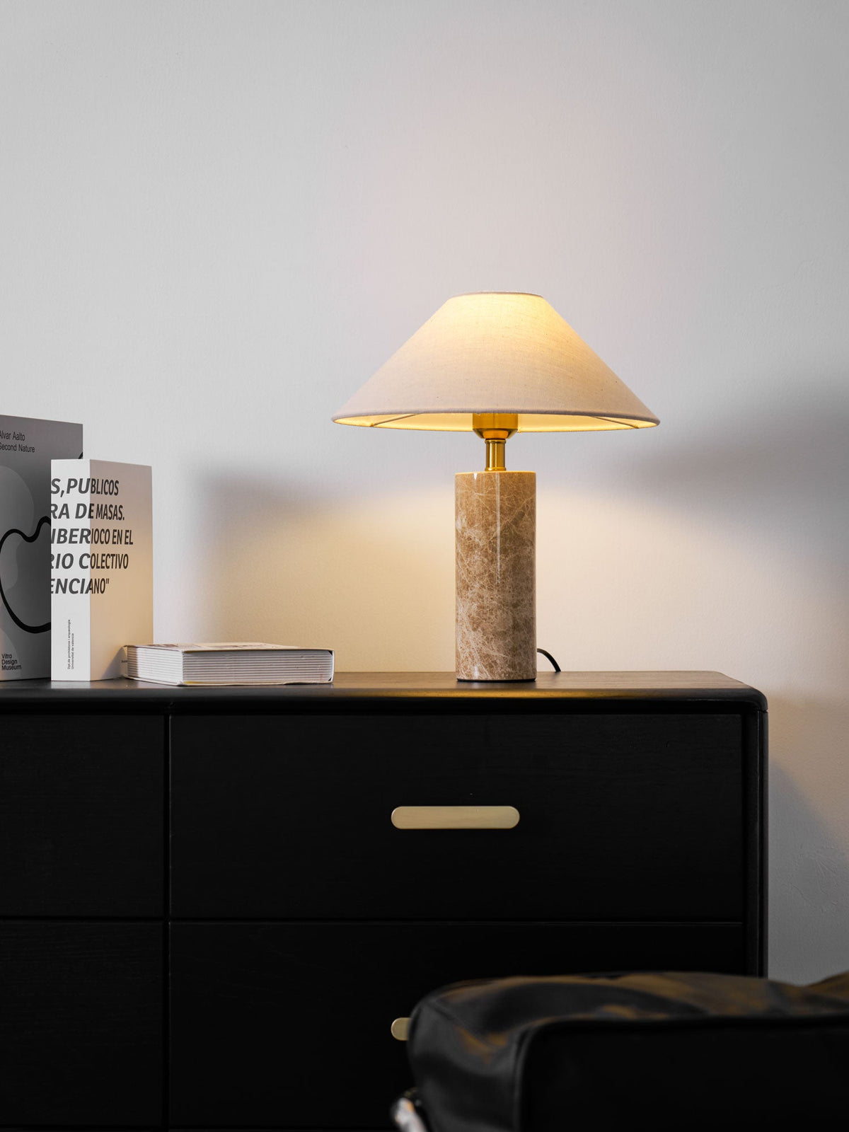 The Clérachic table lamp on the dresser with the books cropped tighter, the black chair now out of frame.