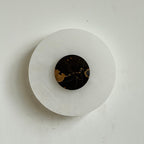Clérachic rauduvyi alabaster wall lamp with a black marble centre disc marked by gold veining, switched off