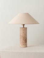 Another angle of the Clérachic table lamp on the plinth, the marble column's grain catching the light.