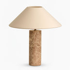Close-up from a low angle of the Clérachic table lamp's shade underside, shown unlit and pale ivory.