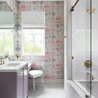White Kristy sconces flanking the mirror in a colourful bathroom with a lilac vanity and brass taps.