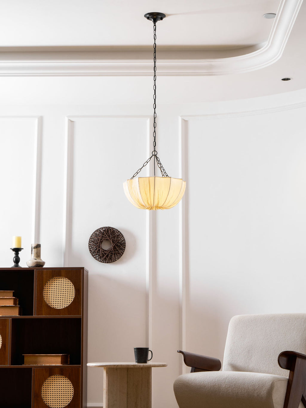 Cotton pendant light shown lit over a dining setting