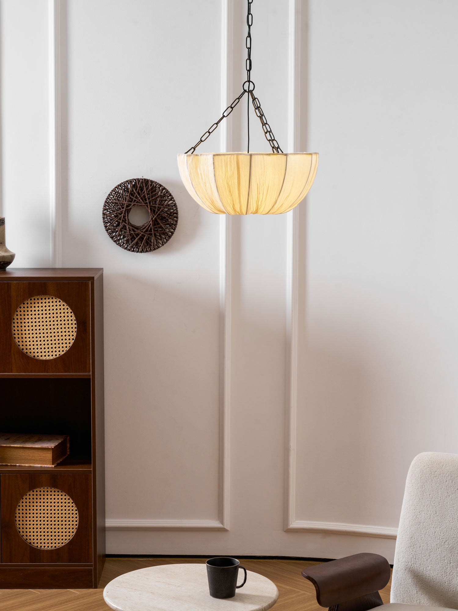 Cotton pendant light glowing warmly in a dim room