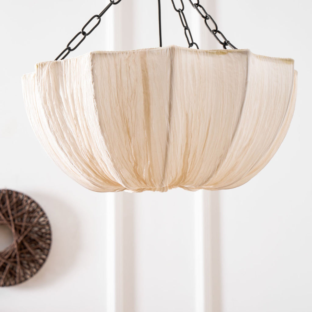 Cotton pendant light shown suspended in a styled space