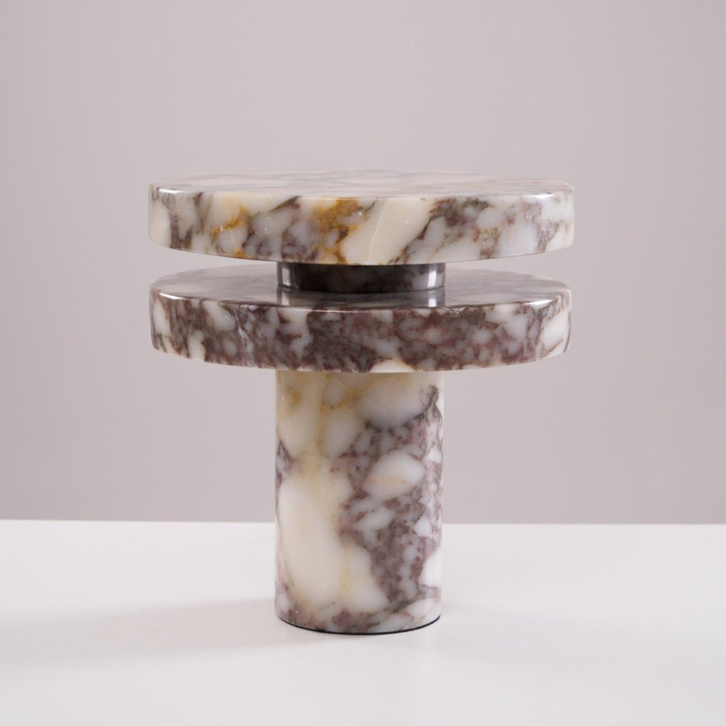 Tighter studio crop of the unlit Clérachic lamp, its stacked marble discs shown straight-on against plain grey.