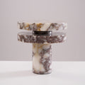 Tighter studio crop of the unlit Clérachic lamp, its stacked marble discs shown straight-on against plain grey.