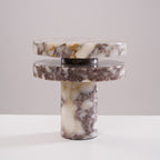 Tighter studio crop of the unlit Clérachic lamp, its stacked marble discs shown straight-on against plain grey.