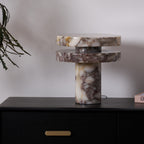 Another view of the Clérachic lamp lit on the dresser, more of the eucalyptus branch visible above the marble discs.