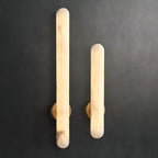 Both sizes lit side by side on dark grey, showing the difference in length between them.