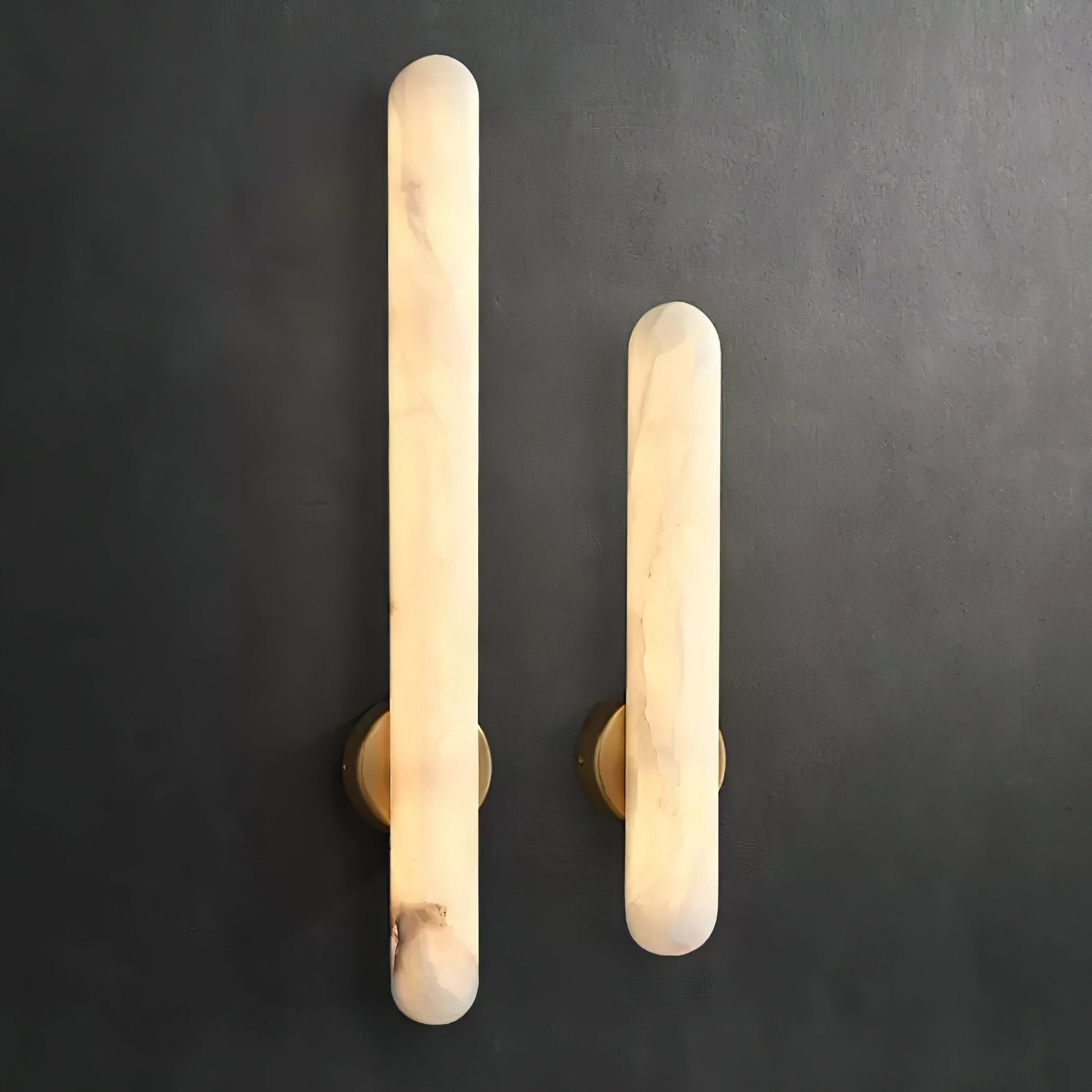 Both sizes lit side by side on dark grey, showing the difference in length between them.