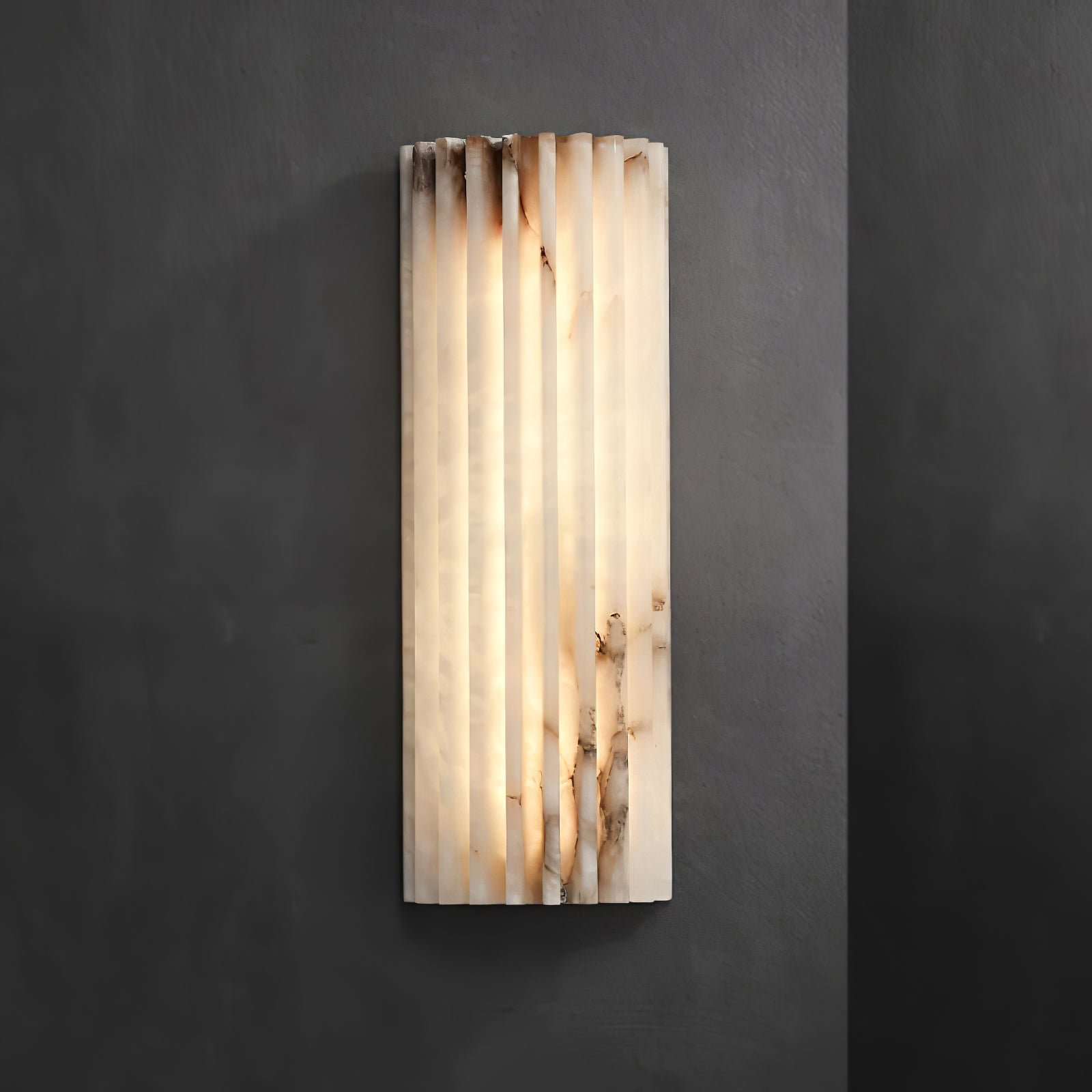 Alabaster wall light mounted in a softly lit corridor