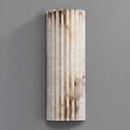 Orcarion alabaster wall light switched off, showing the natural amber and grey veining in the stone.
