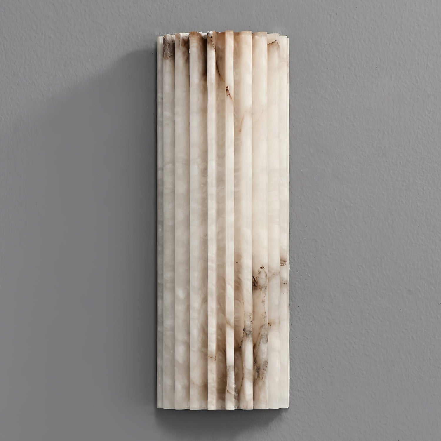 Orcarion alabaster wall light switched off, showing the natural amber and grey veining in the stone.