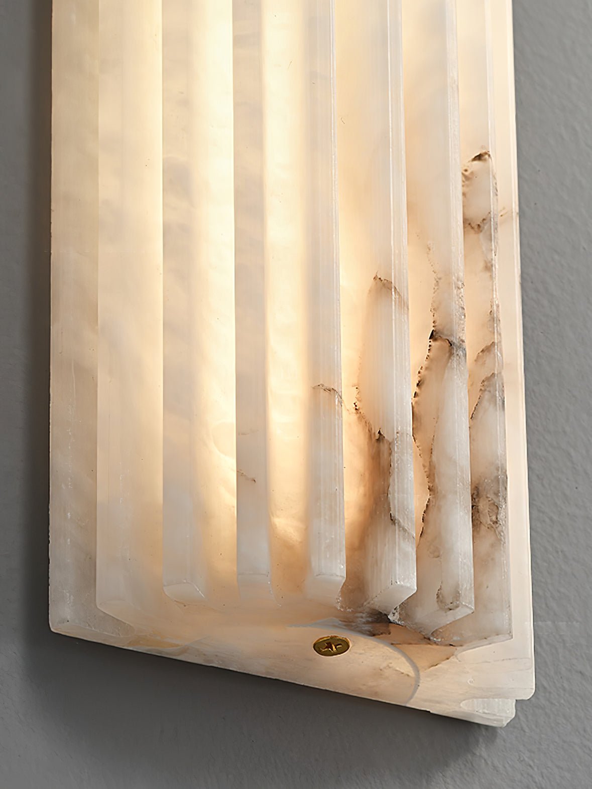 Alabaster wall light highlighting natural grain and translucence