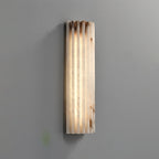Alabaster wall light mounted beside a doorway at night