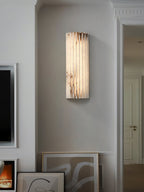 Alabaster wall light showing warm light through ribbed stone