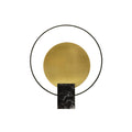 Clérachic table lamp in the black marble finish, gold disc and black ring photographed on a plain white background.