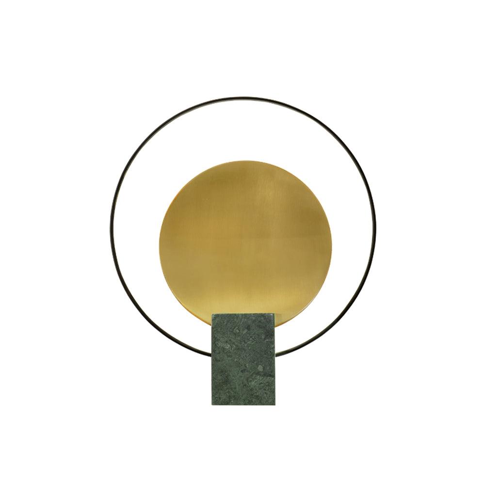 Another studio view of the Clérachic table lamp on white, the black ring framing its brushed gold disc closely.