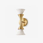 Product shot on a plain white background: this Clérachic sconce's brushed brass hourglass center holds two alabaster shades.