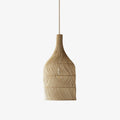 Studio view of this Clérachic pendant, its narrow rattan neck widening into a woven, rounded body.