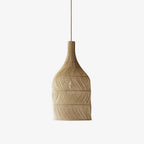 Studio view of this Clérachic pendant, its narrow rattan neck widening into a woven, rounded body.