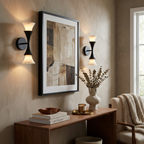 In an entryway beside a framed abstract print, these Clérachic sconces in matte black flank a walnut console table.