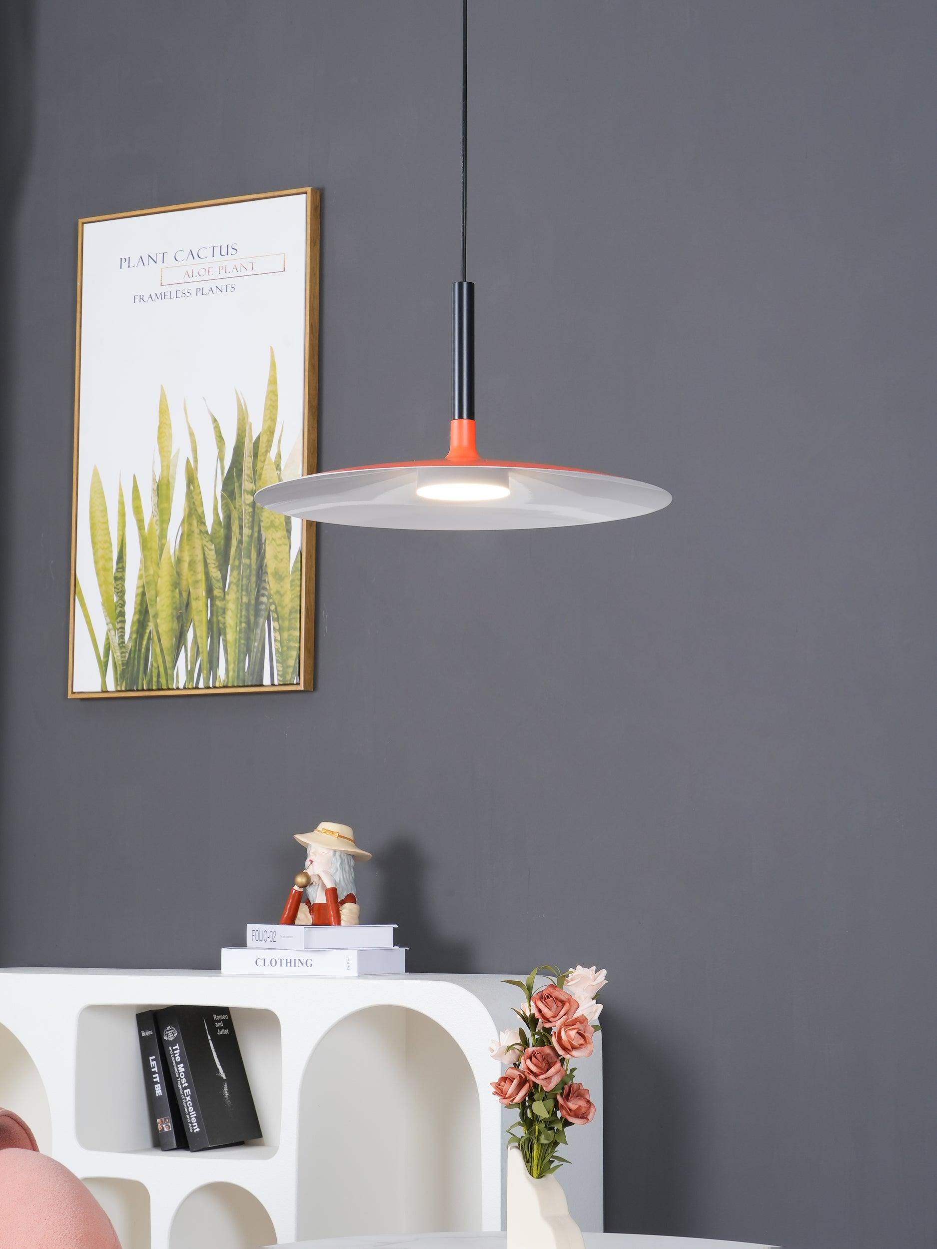 Aluminum pendant light shown suspended over a tabletop