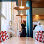 Aluminum pendant light casting a focused pool of light