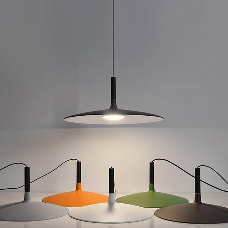 Aluminum pendant light grouped at staggered heights in a room