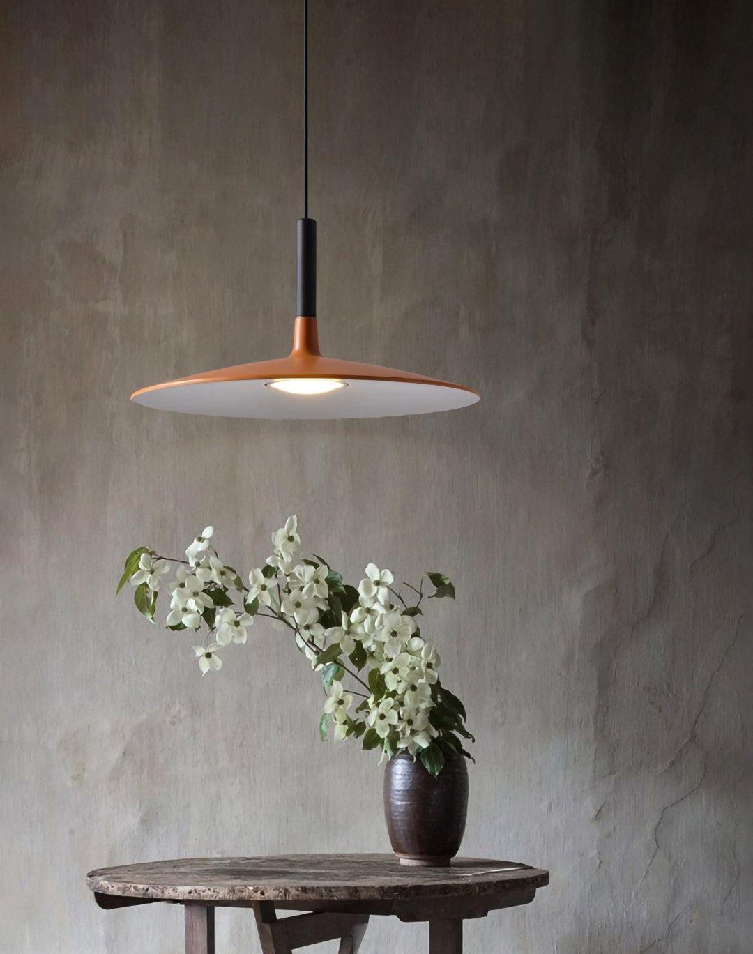 Aluminum pendant light grouped over a long dining table