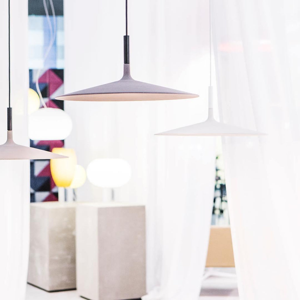Aluminum pendant light shade lit in a cozy interior