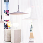 Aluminum pendant light shade lit in a cozy interior