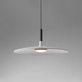Aluminum pendant light shade hanging over a styled interior setting