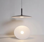 Aluminum pendant light shown hanging in a styled space